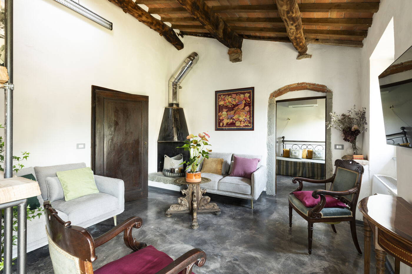 Soggiorno con camino in ferro e archi in pietra